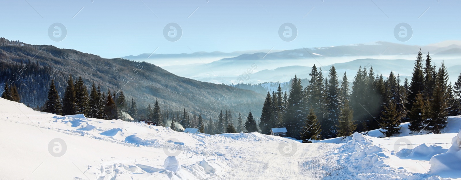 Image of Empty road covered with snow on winter day. Banner design