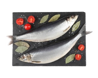 Photo of Slate plate with salted herrings, bay leaves, cherry tomatoes and spices isolated on white, top view
