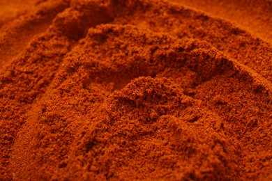 Photo of Aromatic paprika powder as background, closeup view