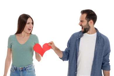Photo of Couple tearing paper heart on white background. Relationship problems