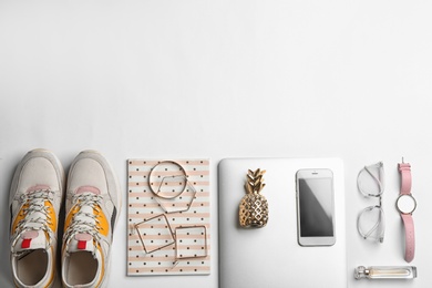 Photo of Flat lay composition with laptop, sneakers, accessories and space for text on white background. Fashion blogger