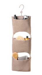 Photo of Stylish knitted organizer with toiletries and brush on white background. Bath accessory