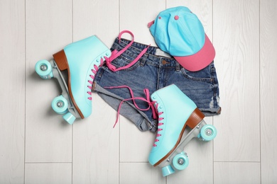 Photo of Flat lay composition with quad roller skates on wooden background