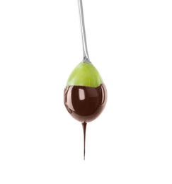 Photo of Tasty grape dipped into chocolate fondue on white background