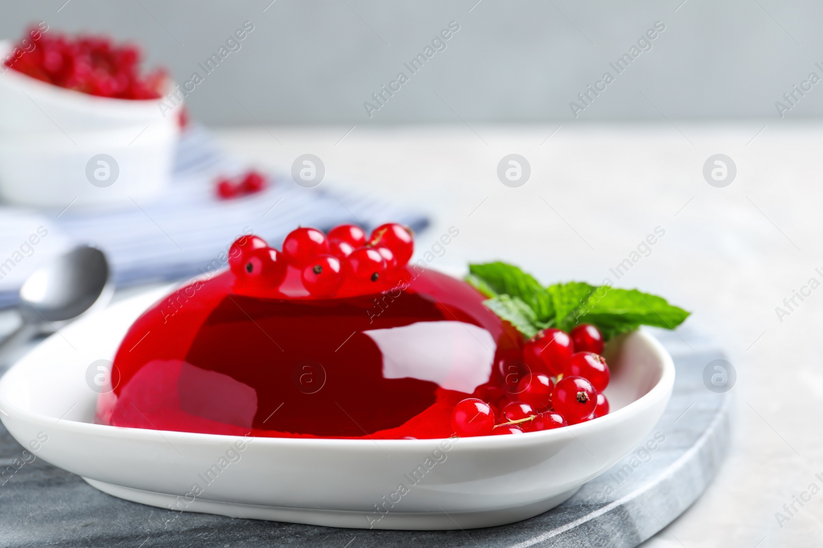 Photo of Delicious jelly with berries and mint on table