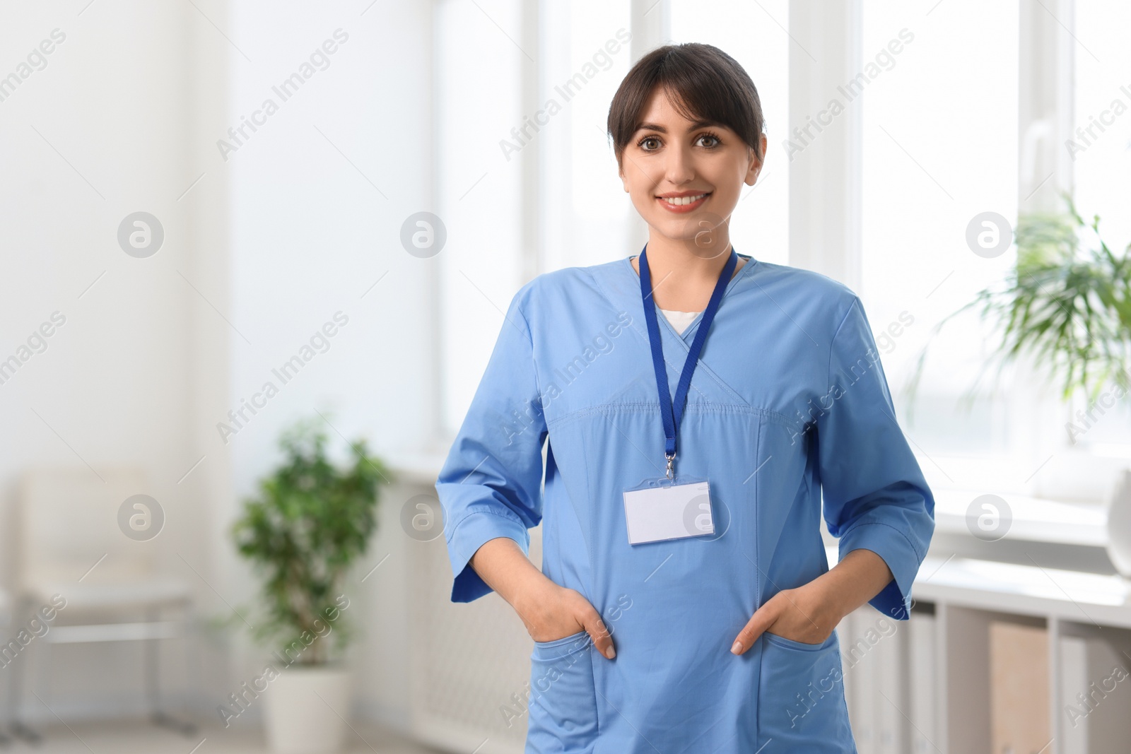 Photo of Portrait of smiling medical assistant in hospital. Space for text