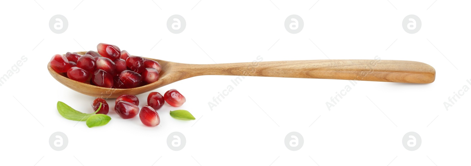 Photo of Ripe juicy pomegranate grains, leaves and wooden spoon isolated on white