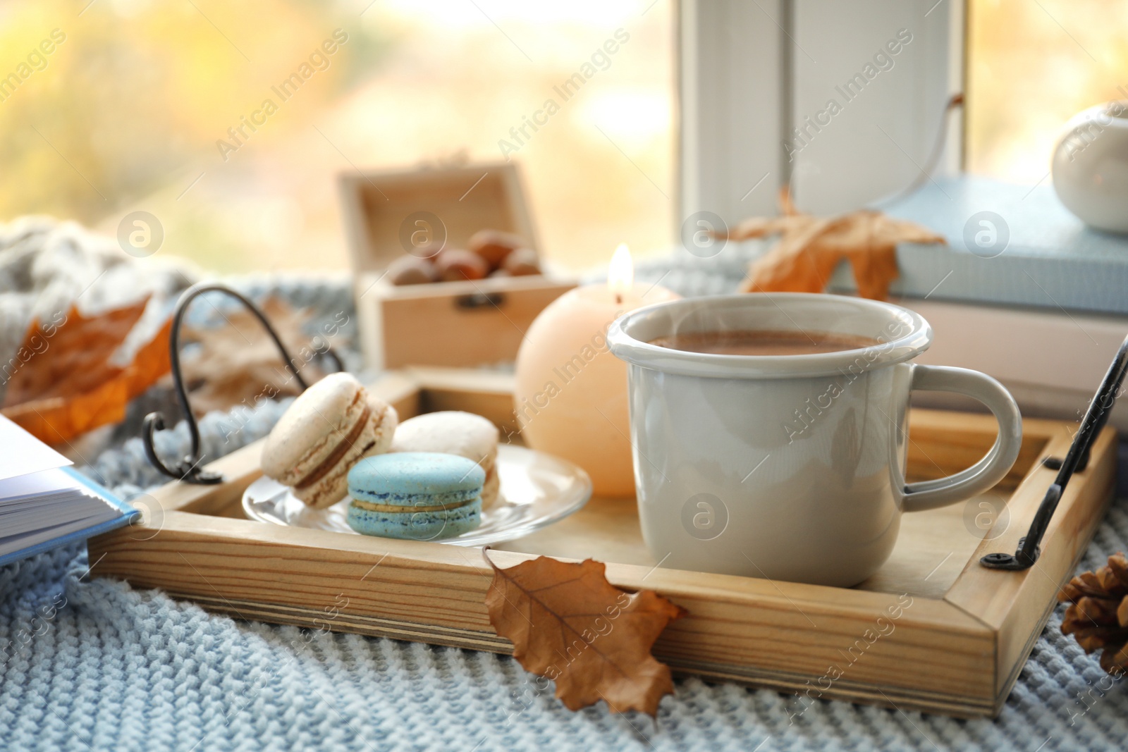 Photo of Tray with breakfast near stack of books on windowsill