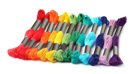 Set of colorful embroidery threads on white background