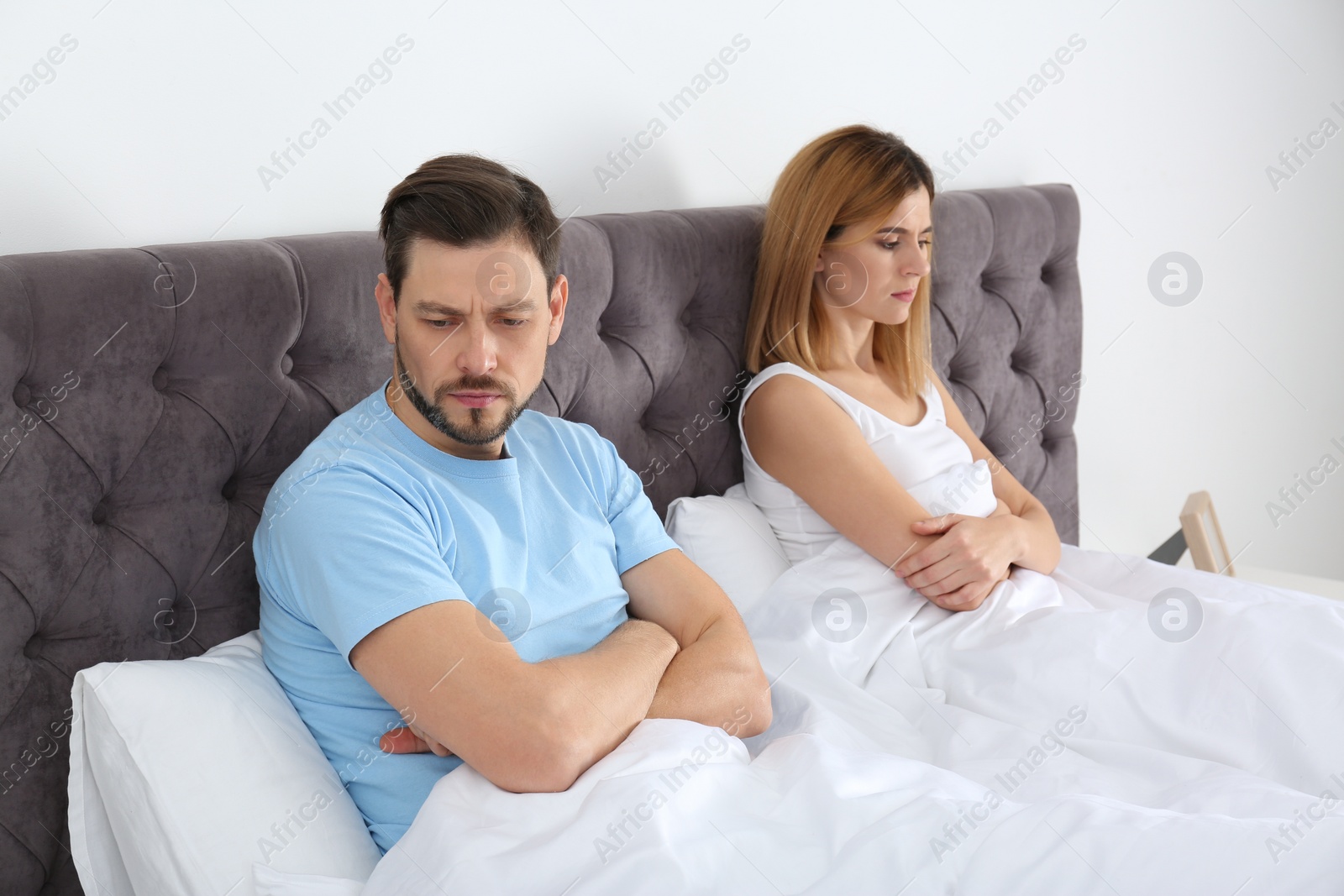 Photo of Couple with relationship problems ignoring each other in bedroom