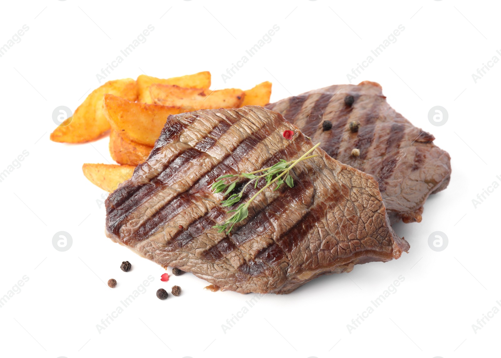 Photo of Delicious grilled beef steaks with fried potatoes isolated on white