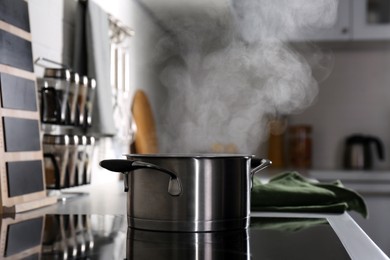 Steaming pot on electric stove in kitchen