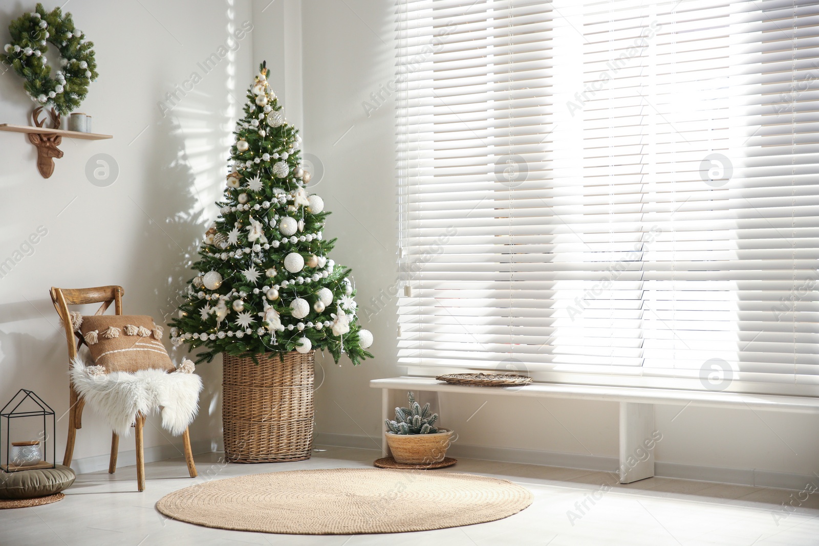 Photo of Beautiful decorated Christmas tree in festive room interior