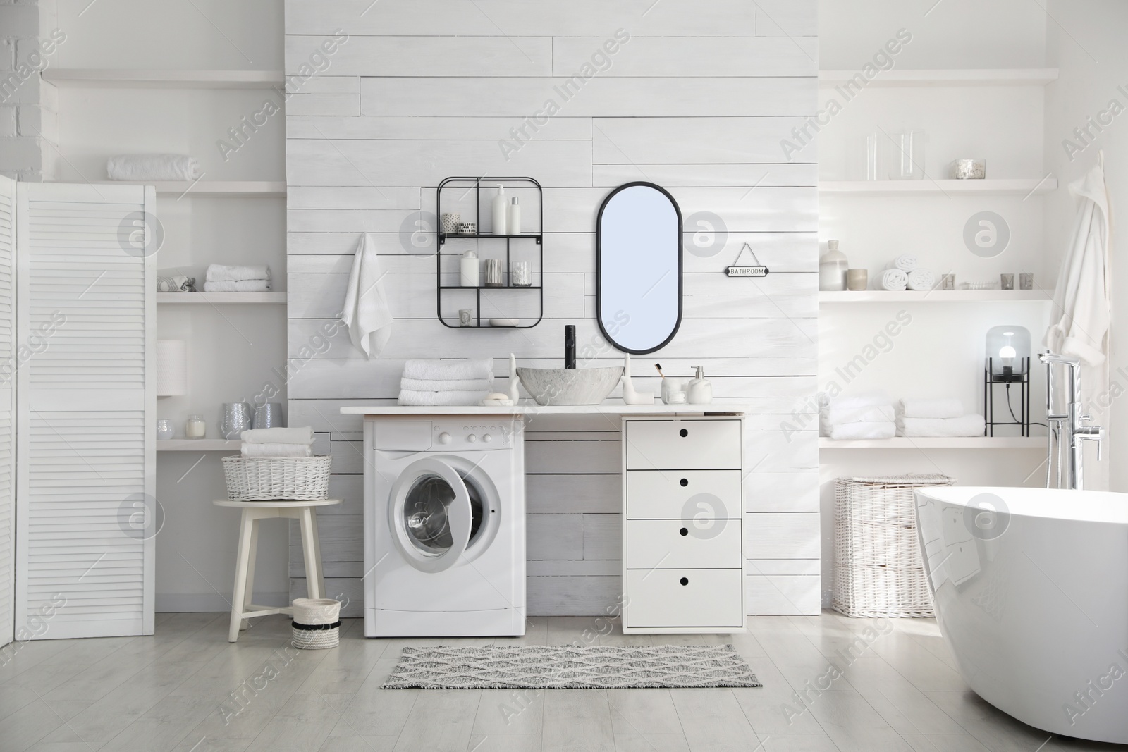 Photo of Stylish bathroom interior with modern washing machine