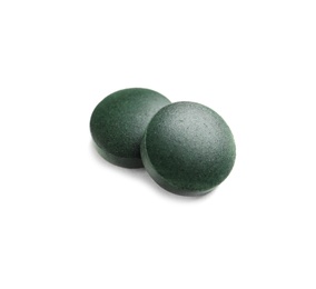 Photo of Spirulina tablets on white background. Healthy lifestyle