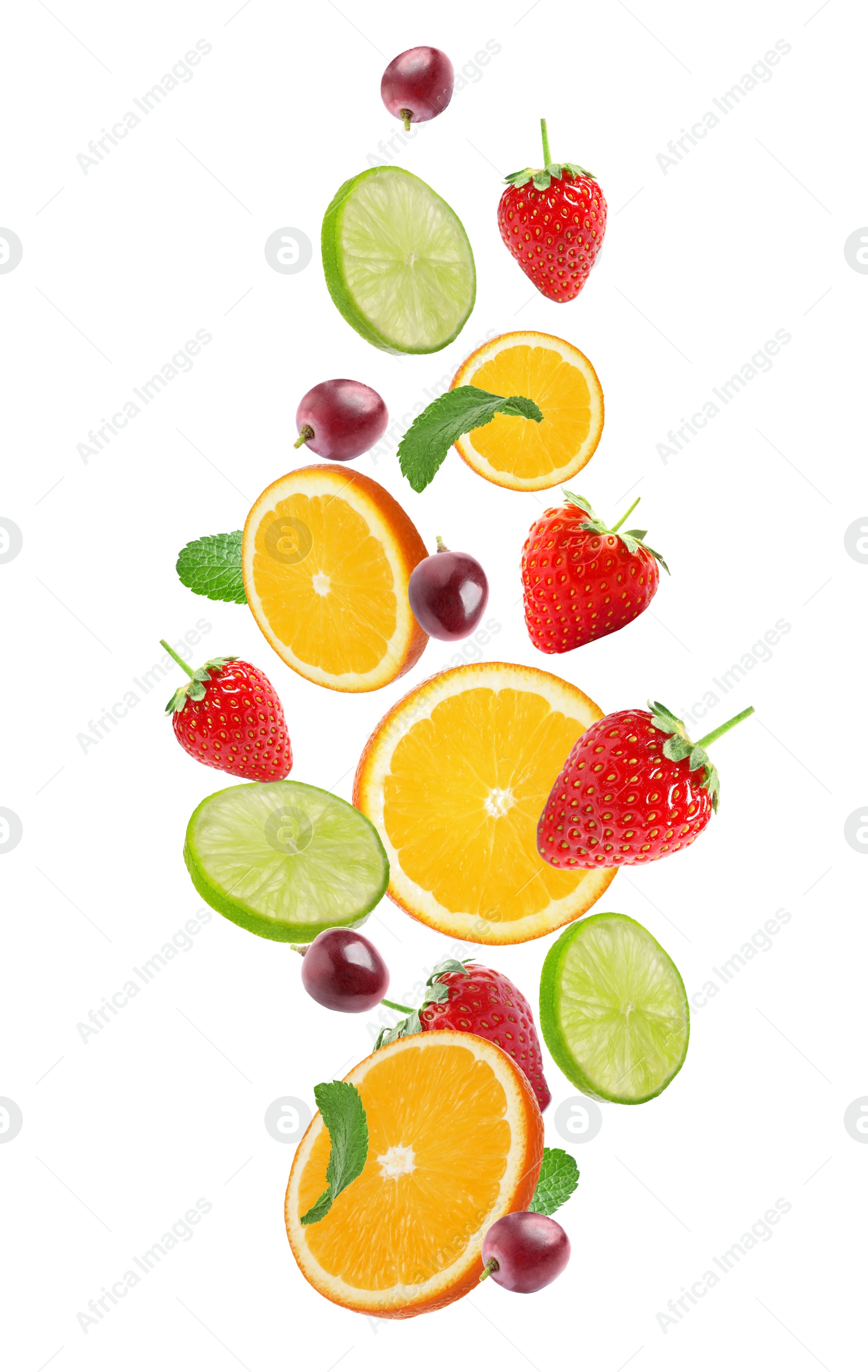 Image of Set of different cut fresh fruits and berries falling on white background