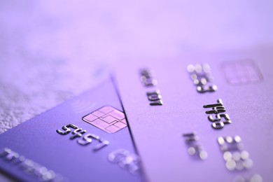 Plastic credit cards on table, closeup view. Color toned