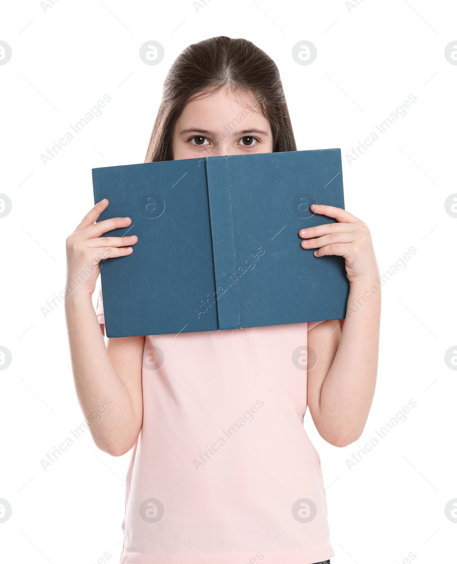 Photo of Cute little girl hiding behind book on white background. Reading activity