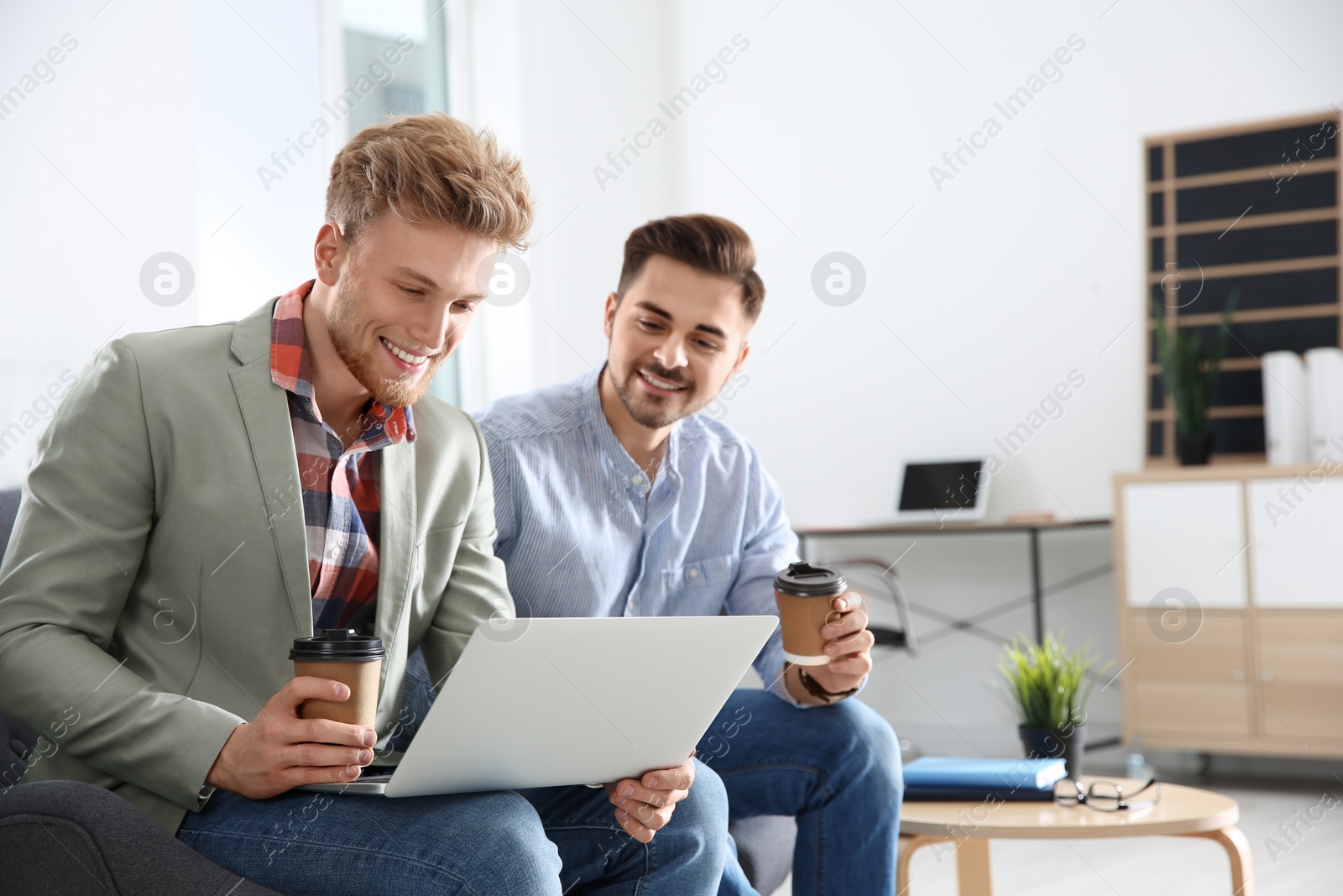 Photo of Business people working on laptop in office, space for text. Professional communication