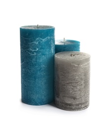 Photo of Different decorative wax candles on white background