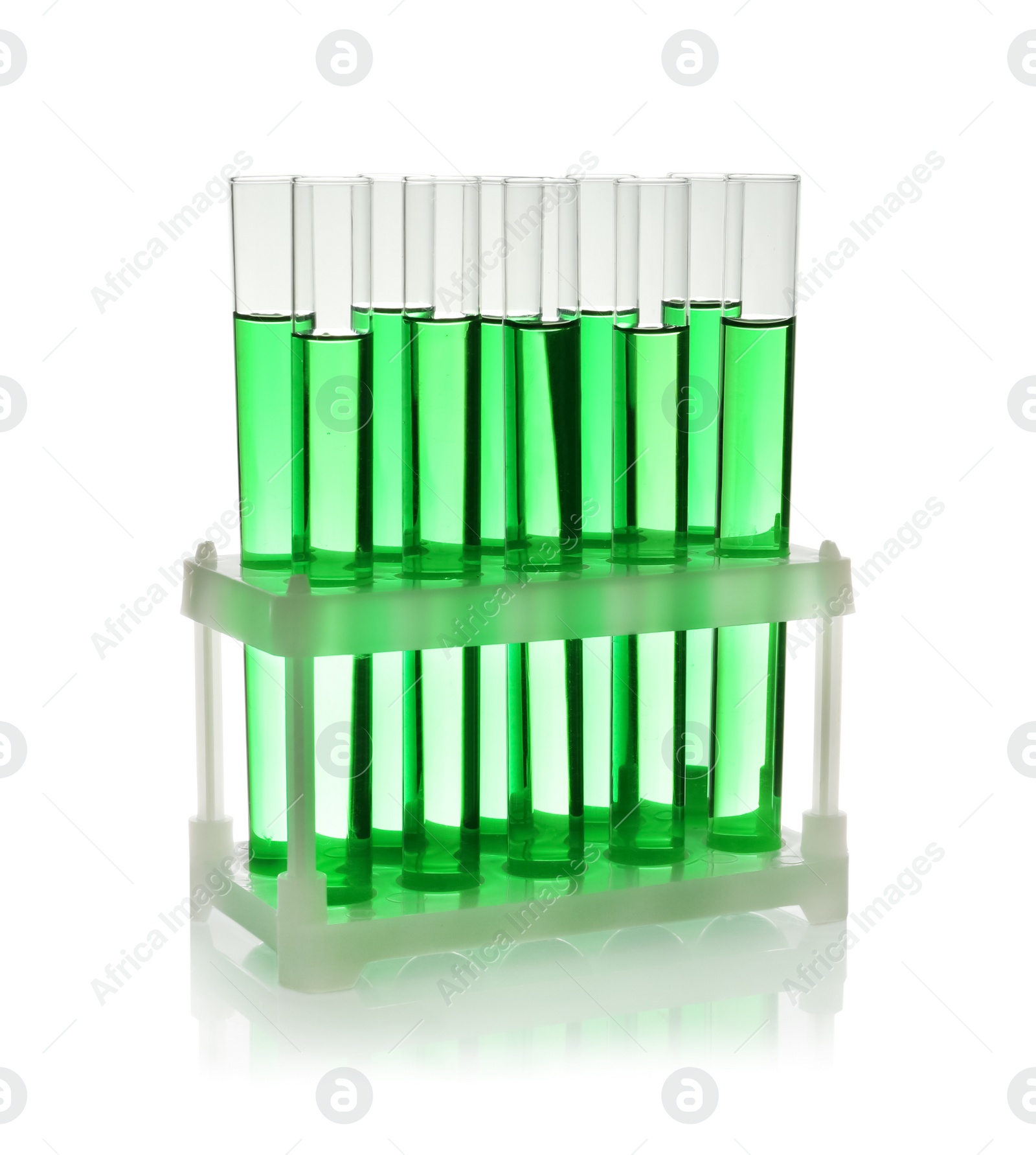 Photo of Test tubes with green liquid on white background