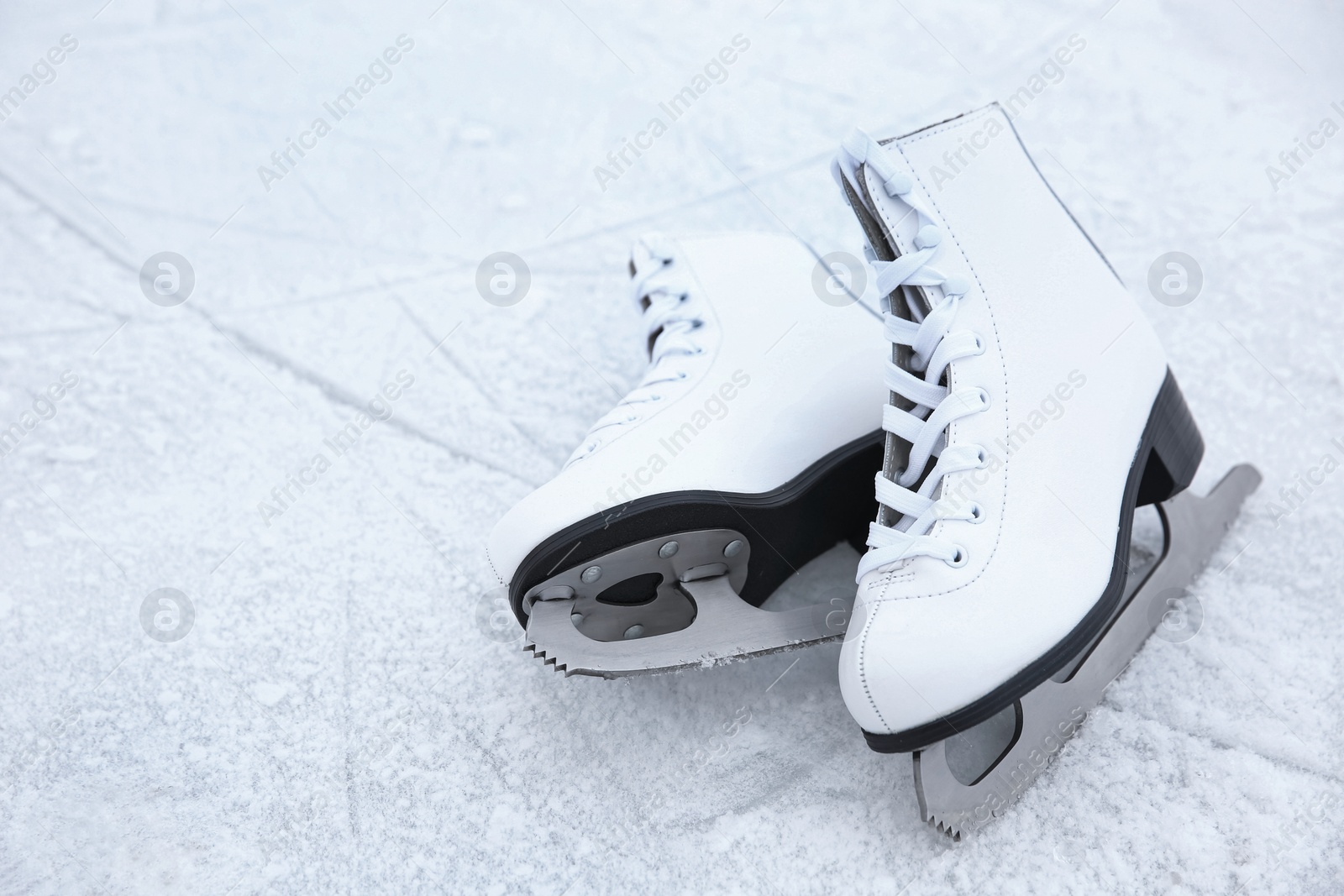 Photo of Pair of figure skates on ice. Winter outdoors activities