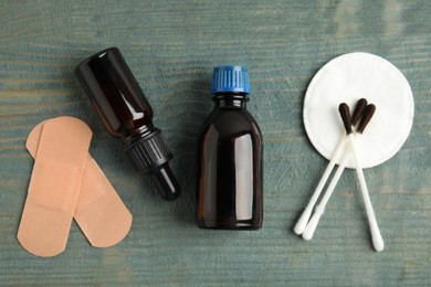 Photo of Flat lay composition with bottles of medical iodine on light blue wooden table