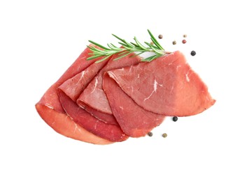 Photo of Slices of tasty bresaola, peppercorns and rosemary isolated on white, top view