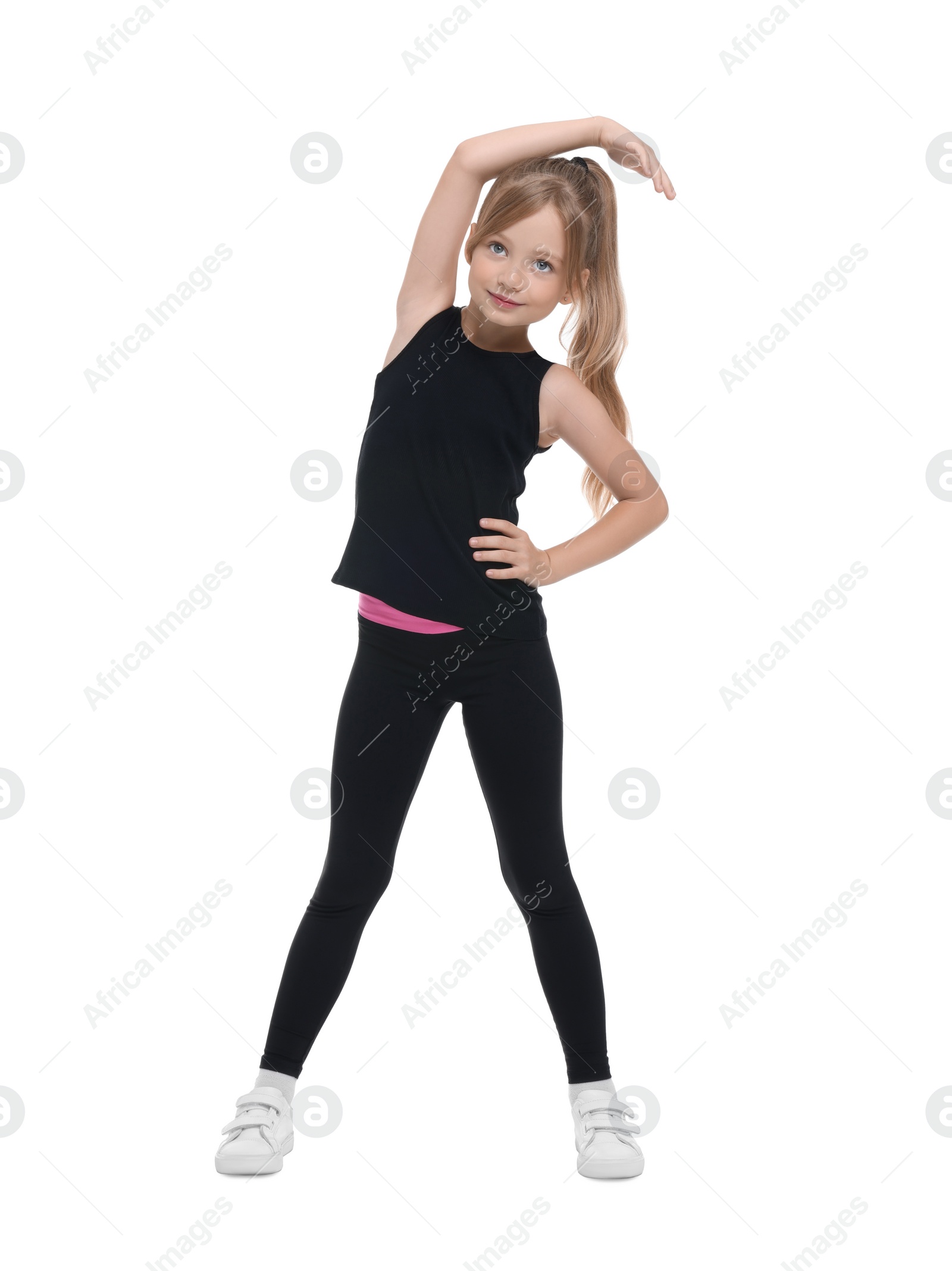 Photo of Little girl doing morning exercise on white background