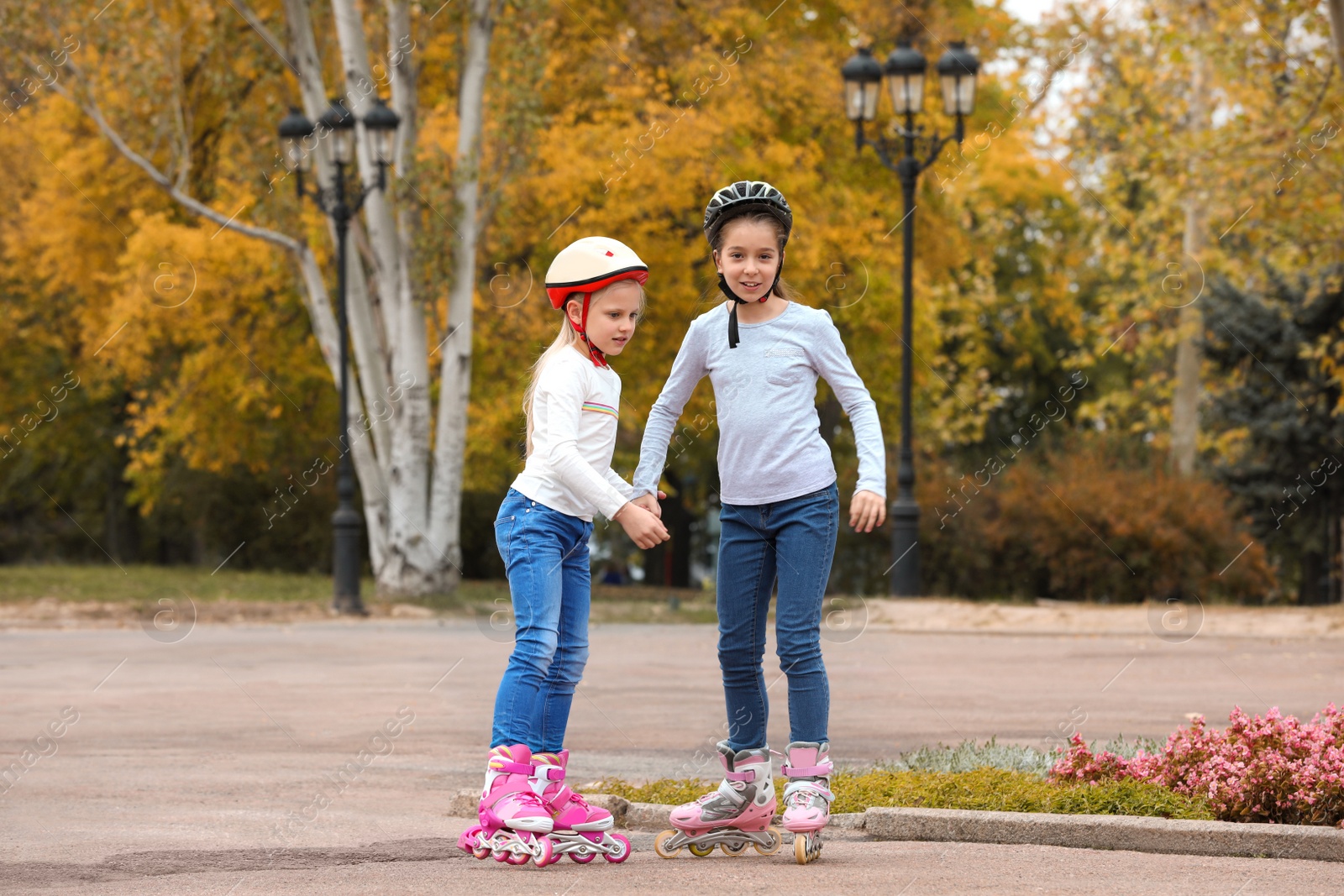 Photo of Happy children roller skating in autumn park