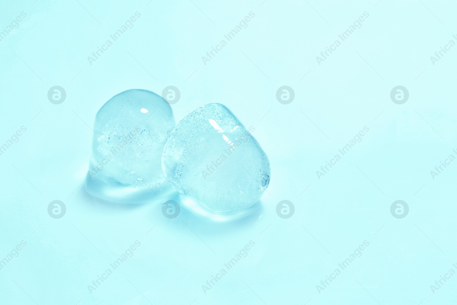Photo of Ice cubes on color background. Space for text