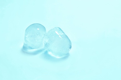 Photo of Ice cubes on color background. Space for text