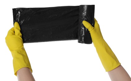Photo of Janitor in rubber gloves holding roll of black garbage bags on white background, closeup