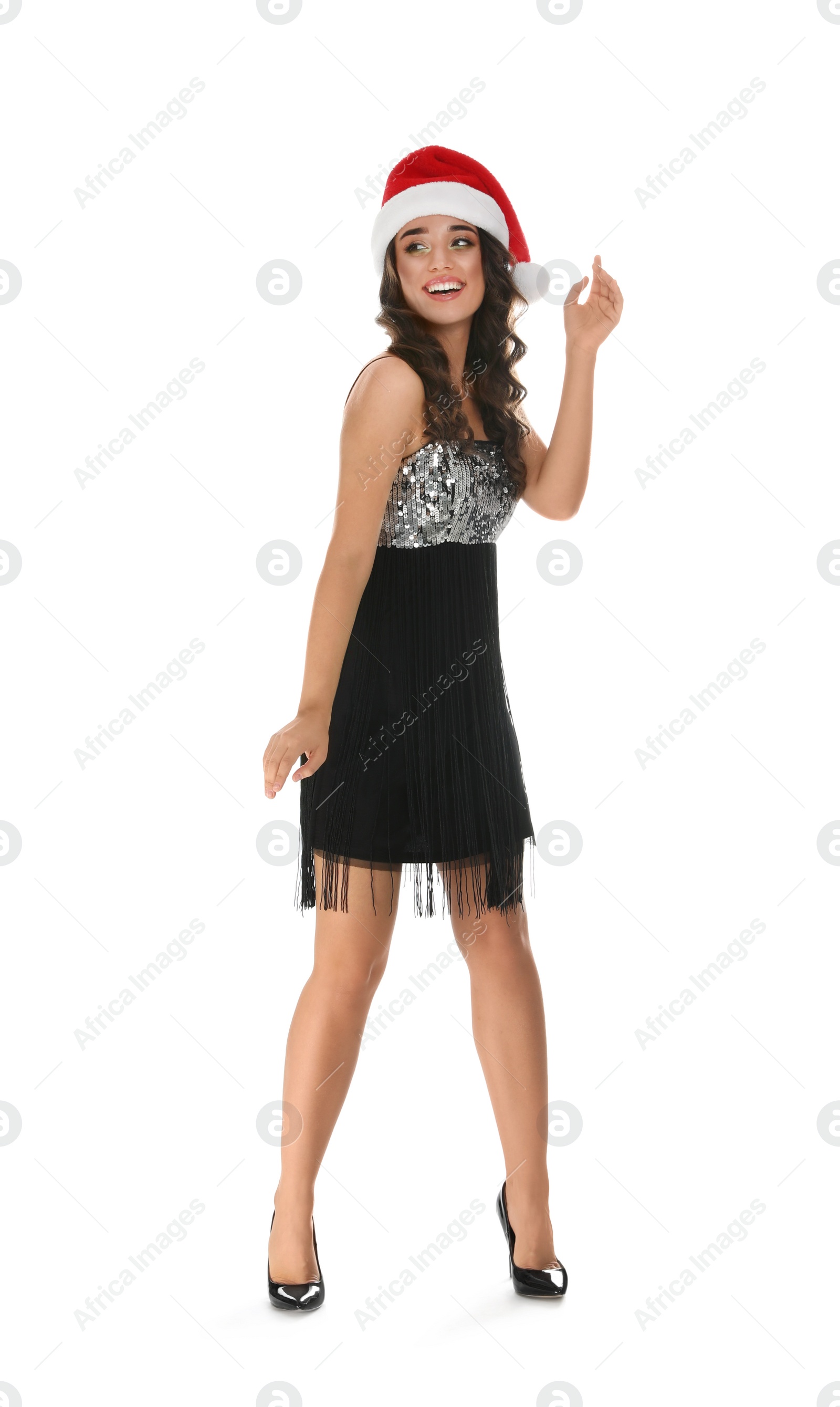 Photo of Beautiful young woman wearing elegant dress and Santa hat on white background. Christmas party