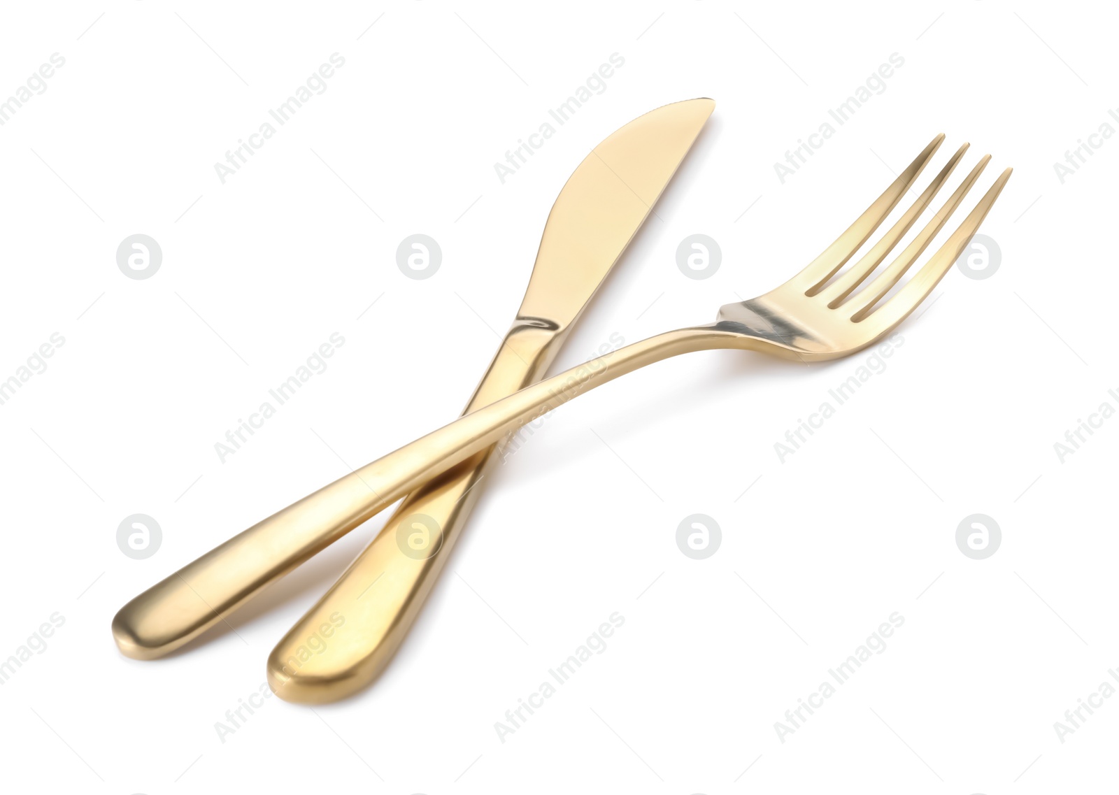 Photo of Shiny golden fork and knife isolated on white. Luxury cutlery