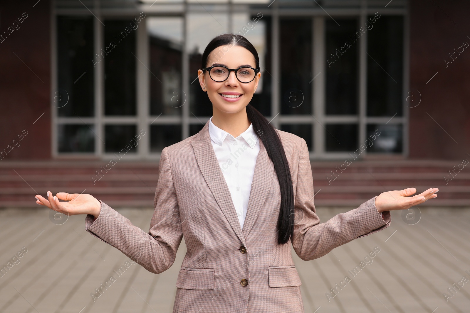 Photo of Beautiful real estate agent in nice suit outdoors