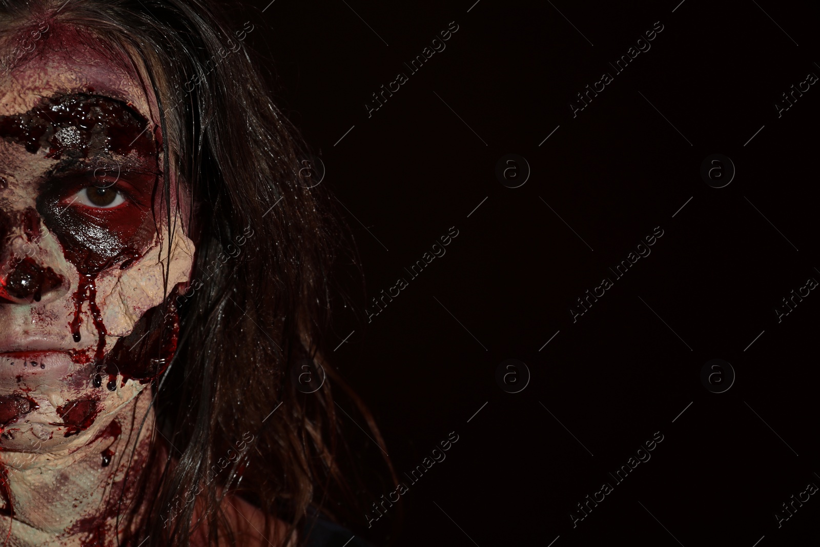 Photo of Scary zombie on dark background, space for text. Halloween monster