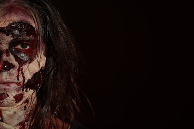 Photo of Scary zombie on dark background, space for text. Halloween monster