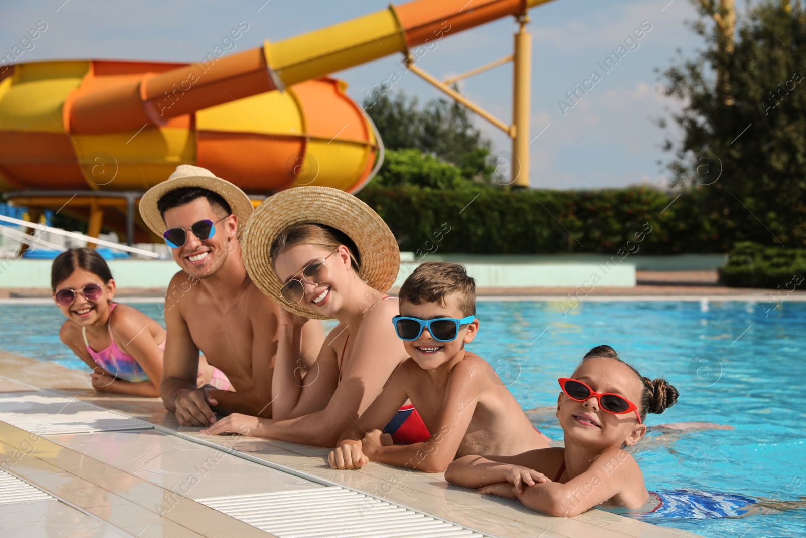 Photo of Happy family in swimming pool at water park