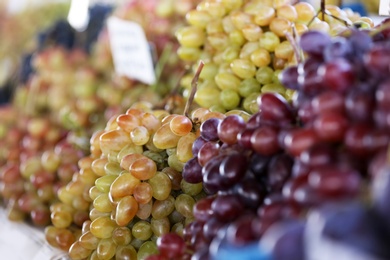 Fresh ripe juicy grapes on counter at market