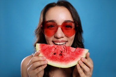 Photo of Beautiful young woman with watermelon on blue background