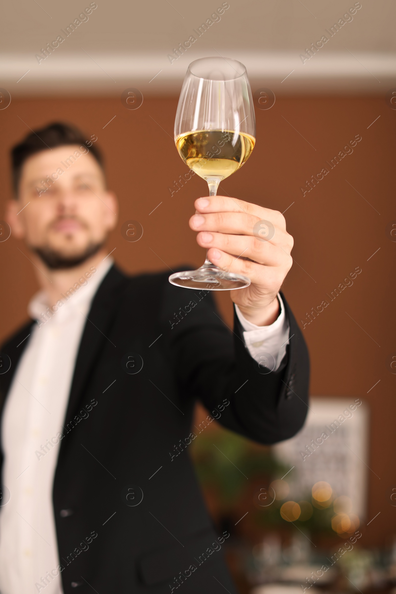 Photo of Young man with glass of wine indoors