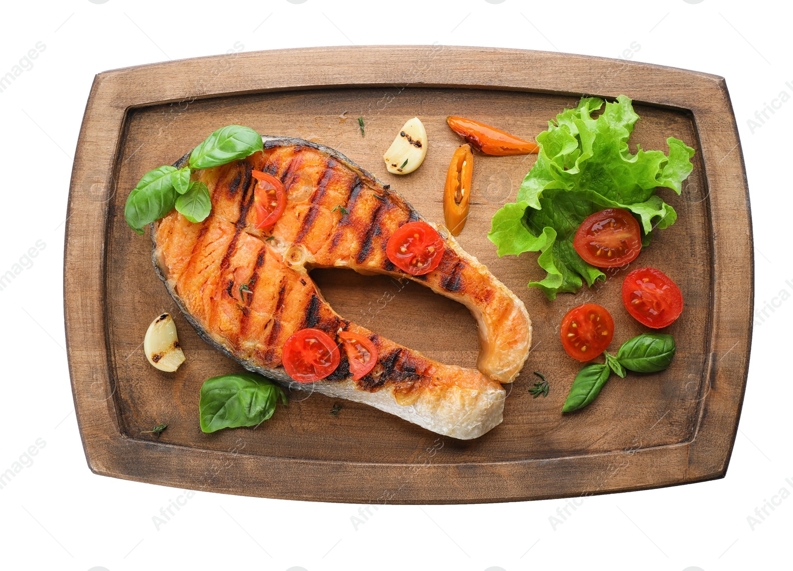 Photo of Wooden board with tasty salmon steak on white background