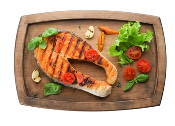 Wooden board with tasty salmon steak on white background