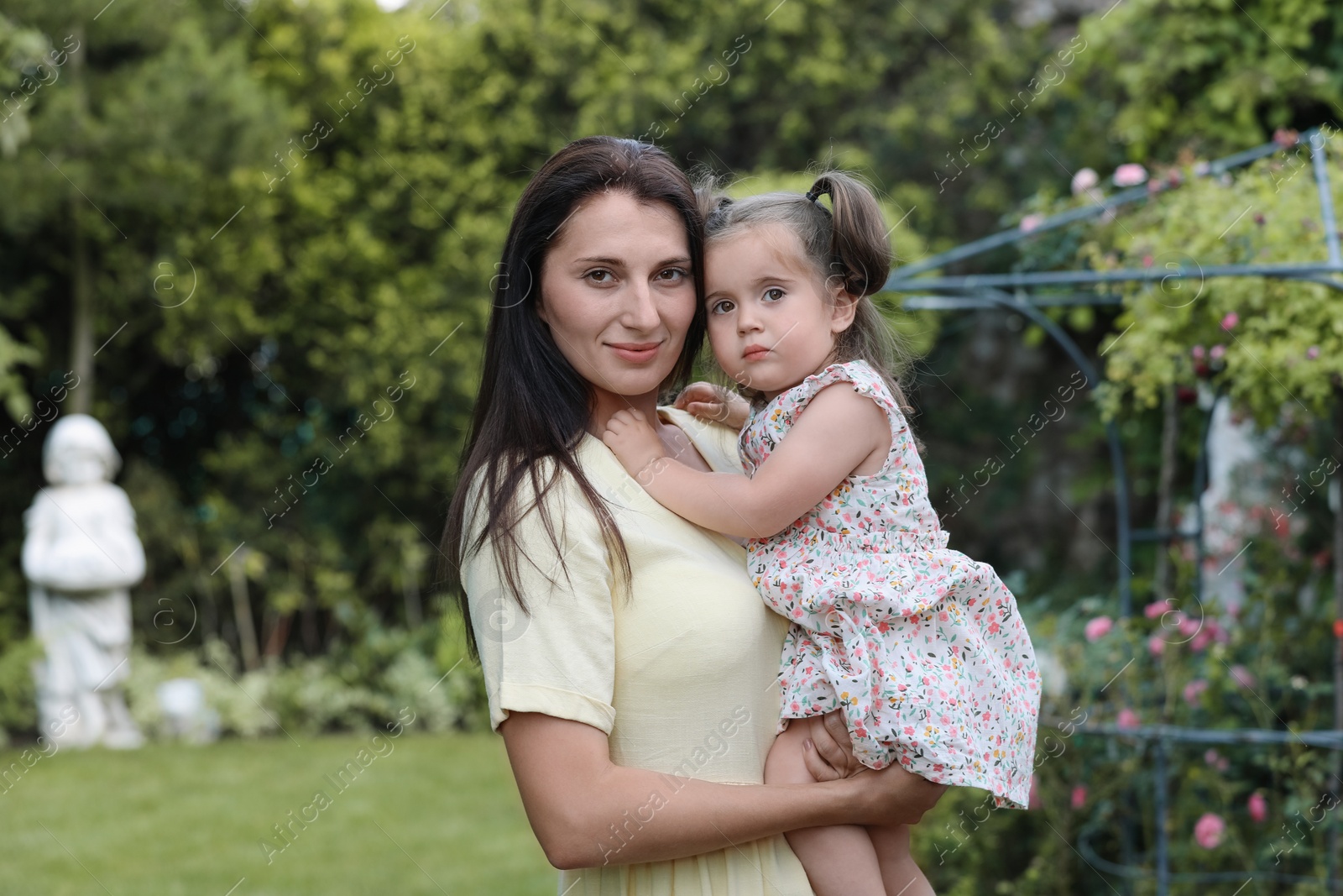 Photo of Mother with her cute daughter spending time together in park