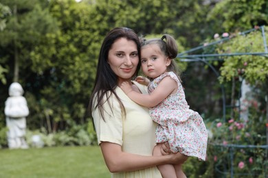 Photo of Mother with her cute daughter spending time together in park