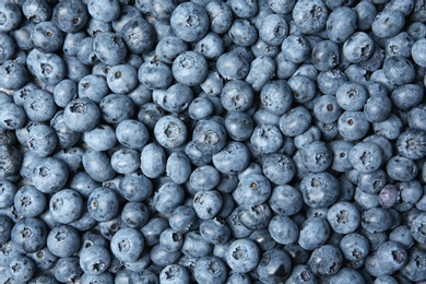 Photo of Freshly picked juicy blueberries as background, top view