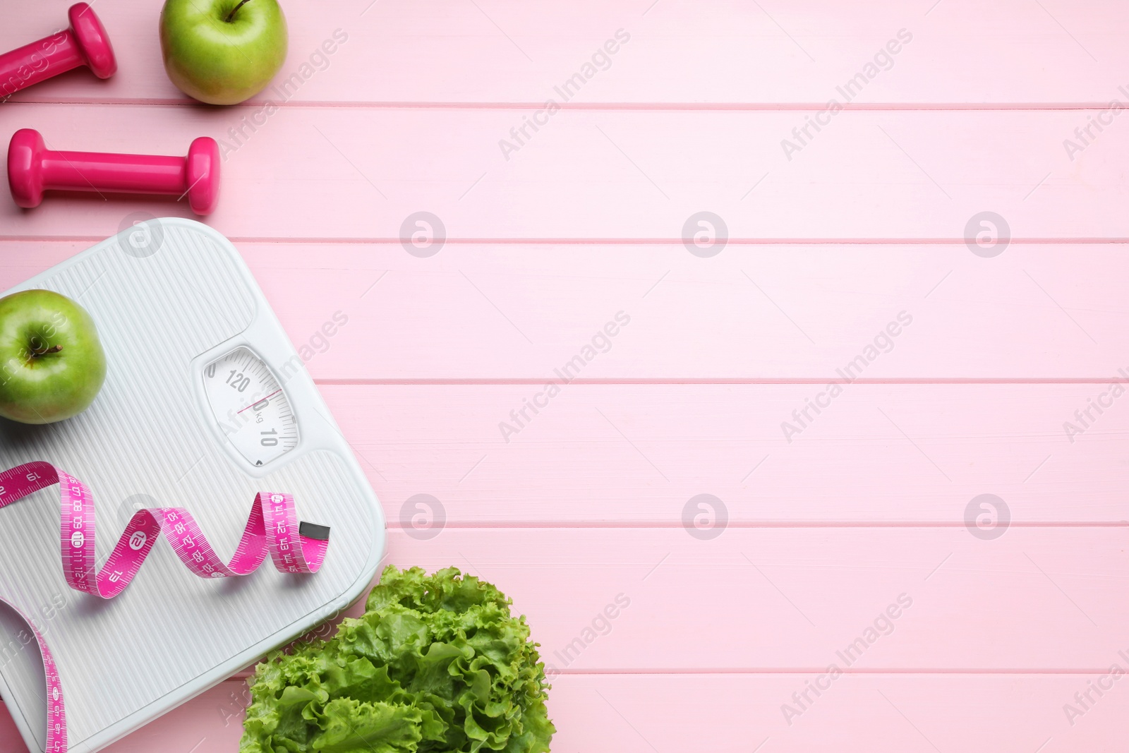 Photo of Flat lay composition with bathroom scale and measuring tape on pink wooden floor , space for text. Weight loss concept