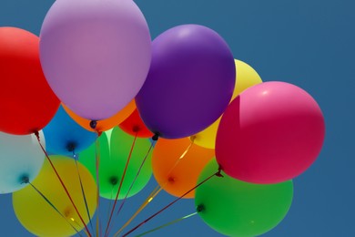 Photo of Bunch of colorful balloons against blue sky