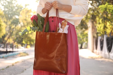 Photo of Woman with leather shopper bag outdoors, closeup